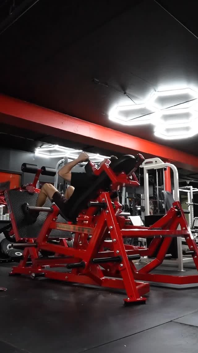 Member training on a plate-loaded leg press at Prodigy Gym